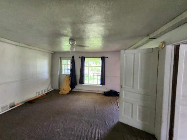 4680 E Kent Rd, Freeland, MI 48623 - unfurnished bedroom featuring carpet floors, a textured ceiling, and a ceiling fan