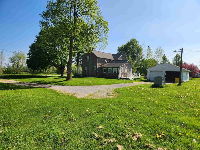 4680 E Kent Rd, Freeland, MI 48623 - view of green lawn with a detached garage and an outbuilding
