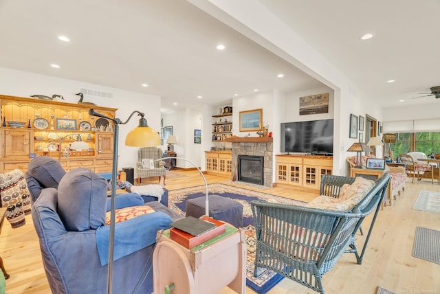 3905 Lakeshore Rd, Lexington, MI 48450 - living room featuring light wood-type flooring, a stone fireplace, a ceiling fan, and recessed lighting