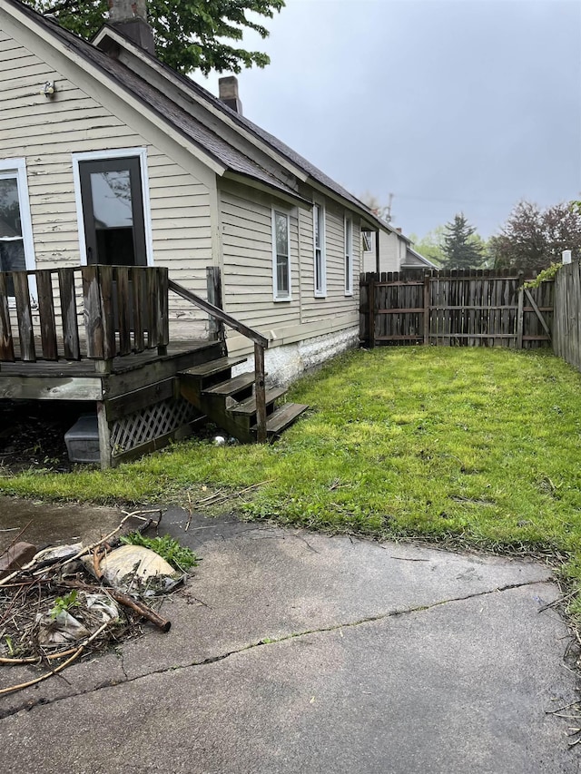 1106 Marsac St, Bay City, MI 48708 - view of side of home featuring a chimney and a deck