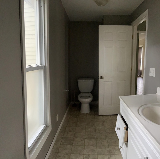1106 Marsac St, Bay City, MI 48708 - bathroom with toilet, healthy amount of natural light, vanity, and baseboards