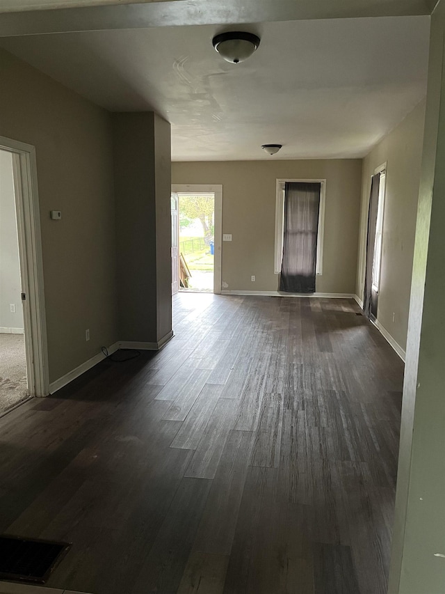 1106 Marsac St, Bay City, MI 48708 - unfurnished living room with dark wood finished floors and baseboards