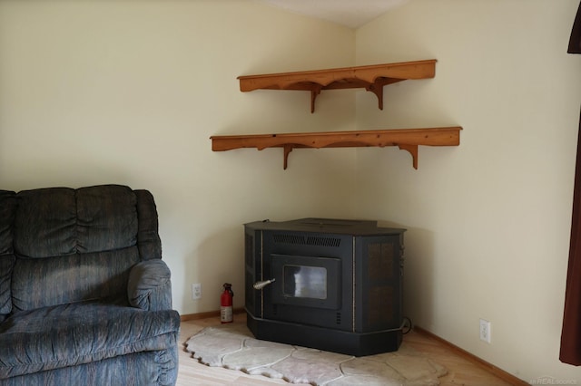 3909 Higgins Rd, Vassar, MI 48768 - living area with a wood stove and baseboards