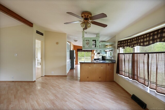 3909 Higgins Rd, Vassar, MI 48768 - kitchen with stainless steel refrigerator with ice dispenser, green cabinetry, a peninsula, dark countertops, and light wood-type flooring
