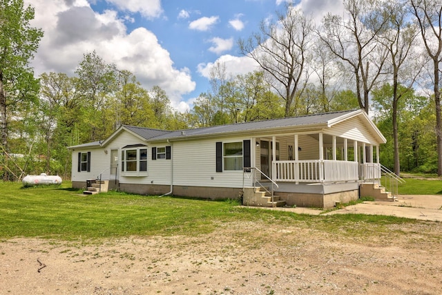 3909 Higgins Rd, Vassar, MI 48768 - view of front of property featuring covered porch, metal roof, and a front yard