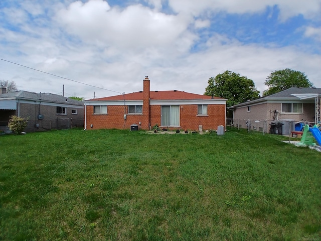 14078 Melva Dr, Warren, MI 48088 - back of house featuring a chimney and brick siding