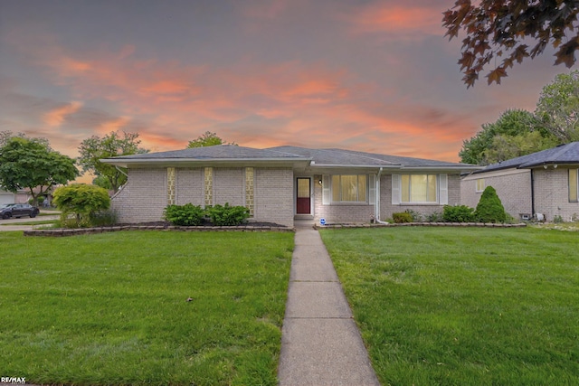 37601 Dartmouth Dr, Sterling Heights, MI 48310 - view of front of home with a front lawn and brick siding