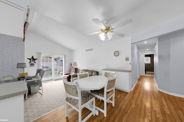 37601 Dartmouth Dr, Sterling Heights, MI 48310 - dining room with lofted ceiling, light wood finished floors, a ceiling fan, a textured ceiling, and baseboards