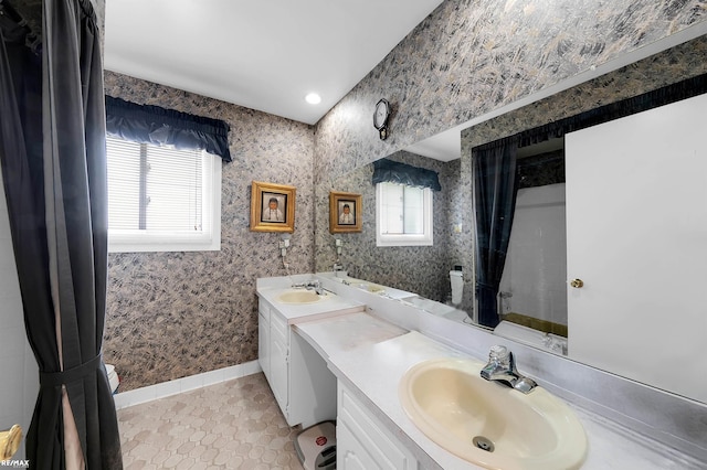 37601 Dartmouth Dr, Sterling Heights, MI 48310 - bathroom with tile patterned floors, double vanity, baseboards, and wallpapered walls