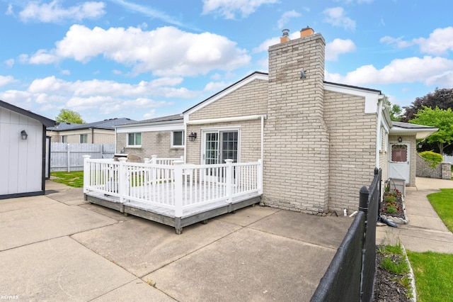 37601 Dartmouth Dr, Sterling Heights, MI 48310 - rear view of property featuring a deck, a chimney, a patio, and brick siding