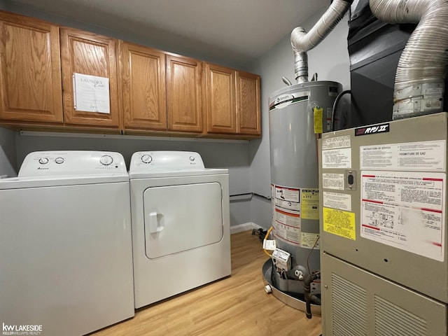 7314 Aspen Rd, Lexington, MI 48450 - laundry room with gas water heater, cabinet space, independent washer and dryer, light wood-style floors, and heating unit
