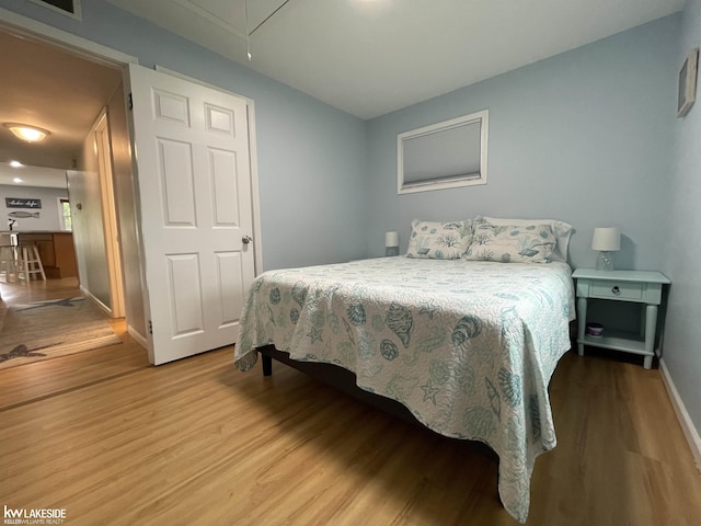 7314 Aspen Rd, Lexington, MI 48450 - bedroom featuring wood finished floors, attic access, and baseboards