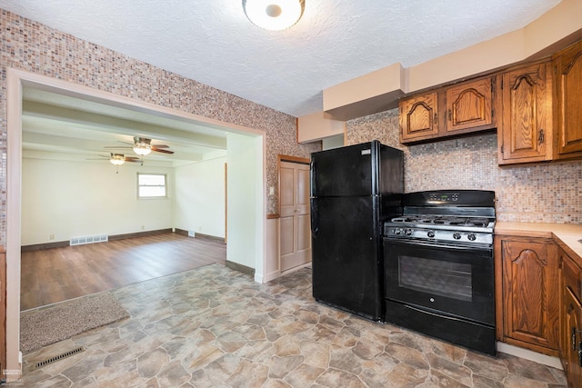 21036 Suffolk St, Clinton Township, MI 48035 - kitchen featuring black appliances, brown cabinets, a ceiling fan, light countertops, and backsplash