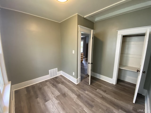 317 Lane Ave, Iron Mountain, MI 49802 - unfurnished bedroom with wood finished floors, baseboards, and a closet