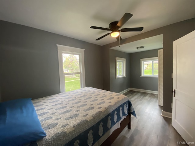 317 Lane Ave, Iron Mountain, MI 49802 - bedroom featuring wood finished floors, baseboards, and a ceiling fan
