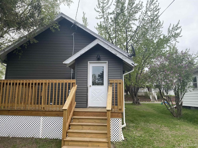 317 Lane Ave, Iron Mountain, MI 49802 - back of house featuring a lawn and a wooden deck