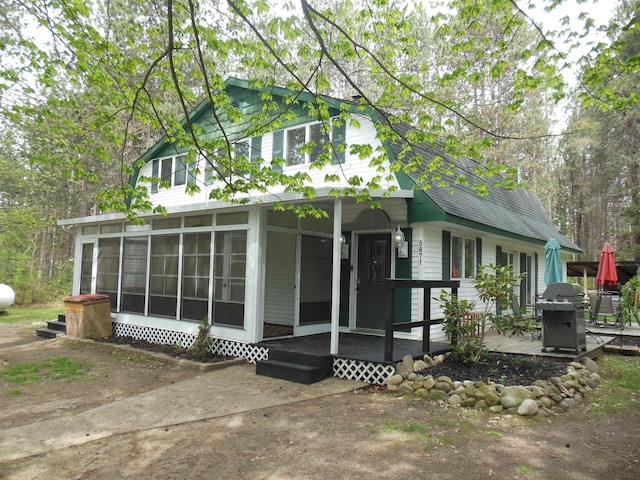 5871 Edith Schneider Rd, Harrison, MI 48625 - view of front of house featuring a sunroom and roof with shingles