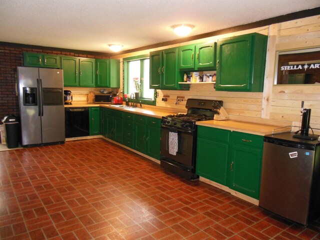 5871 Edith Schneider Rd, Harrison, MI 48625 - kitchen with black appliances, green cabinets, brick patterned flooring, light countertops, and wooden walls