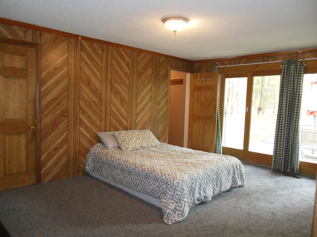 5871 Edith Schneider Rd, Harrison, MI 48625 - bedroom featuring carpet flooring, multiple windows, access to outside, wood walls, and a textured ceiling