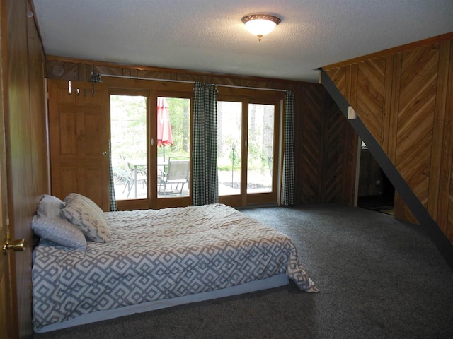 5871 Edith Schneider Rd, Harrison, MI 48625 - carpeted bedroom featuring access to outside, a textured ceiling, and wood walls