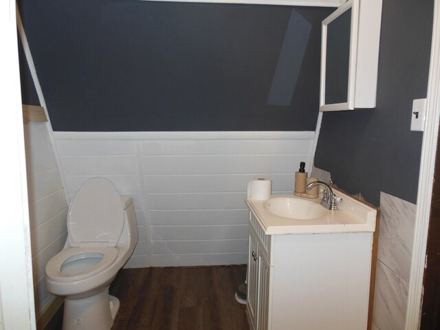 5871 Edith Schneider Rd, Harrison, MI 48625 - half bathroom with vanity, toilet, wainscoting, and wood finished floors