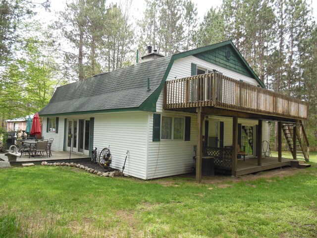5871 Edith Schneider Rd, Harrison, MI 48625 - back of property with a gambrel roof, stairway, a deck, a patio area, and a lawn