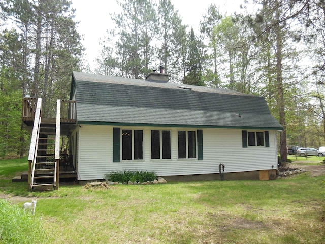5871 Edith Schneider Rd, Harrison, MI 48625 - back of house with stairway, a gambrel roof, a yard, a wooden deck, and a chimney