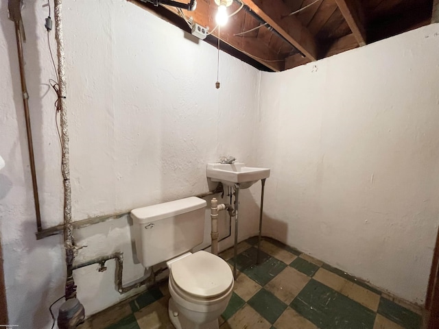 19993 Woodmont St, Harper Woods, MI 48225 - half bathroom featuring tile patterned floors, toilet, and a sink