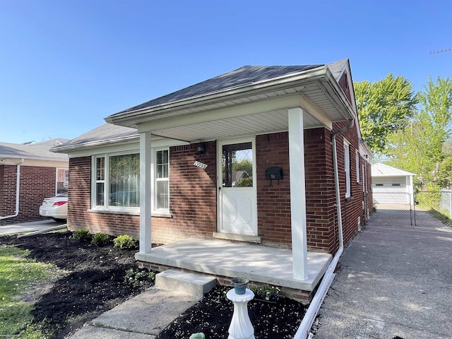 19993 Woodmont St, Harper Woods, MI 48225 - doorway to property featuring brick siding and a shingled roof