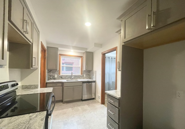 19993 Woodmont St, Harper Woods, MI 48225 - kitchen with appliances with stainless steel finishes, a sink, gray cabinetry, decorative backsplash, and light stone countertops