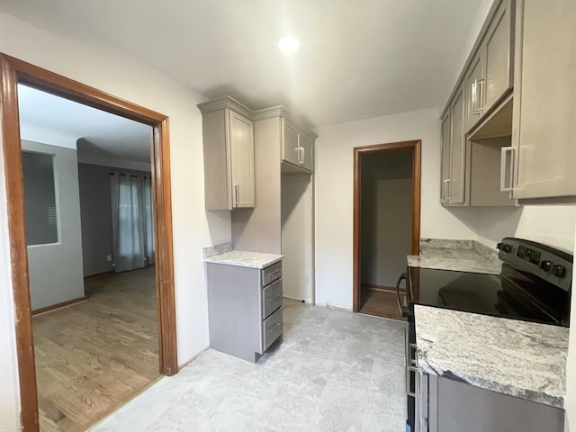 19993 Woodmont St, Harper Woods, MI 48225 - kitchen featuring gray cabinetry, electric range oven, and light stone countertops
