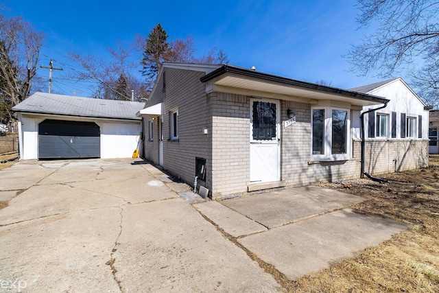3168 Herbell Dr, Waterford, MI 48328 - view of front of house featuring a detached garage, an outdoor structure, and brick siding