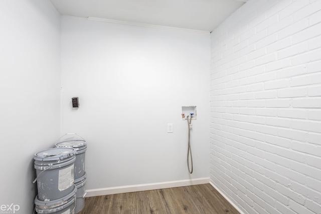 3168 Herbell Dr, Waterford, MI 48328 - laundry room with dark wood-style floors, baseboards, and brick wall