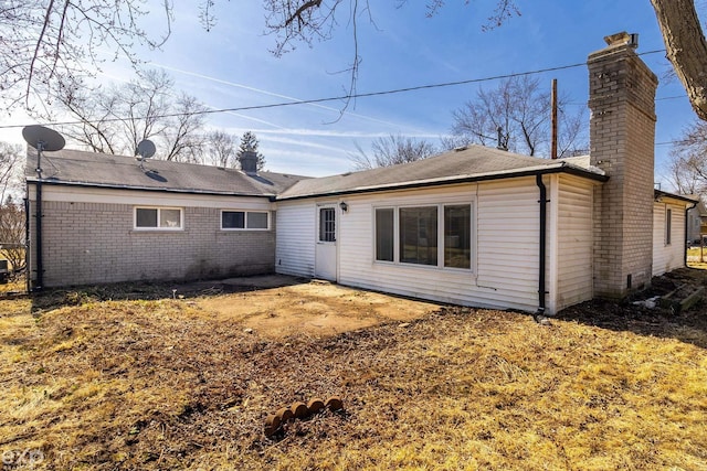 3168 Herbell Dr, Waterford, MI 48328 - back of property featuring a chimney, brick siding, a patio, and roof with shingles