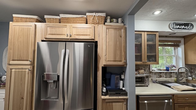 7741 White Birch St, Farwell, MI 48622 - kitchen featuring stainless steel appliances, backsplash, glass insert cabinets, and light brown cabinetry