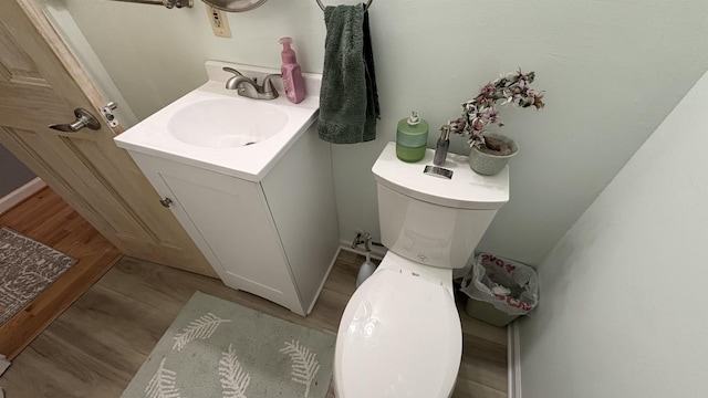 7741 White Birch St, Farwell, MI 48622 - bathroom with toilet, vanity, and wood finished floors