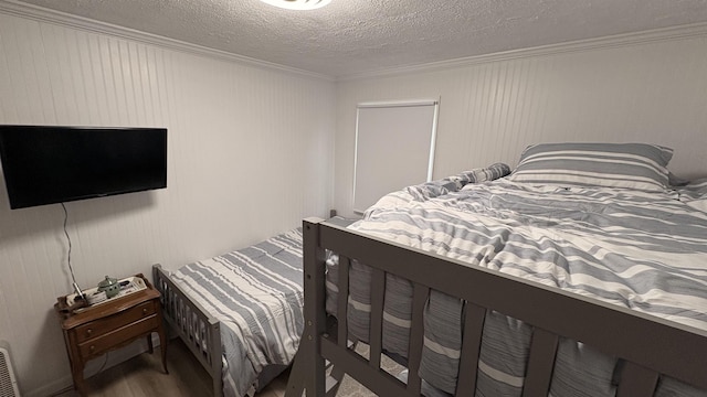 7741 White Birch St, Farwell, MI 48622 - bedroom featuring ornamental molding, wood finished floors, and a textured ceiling
