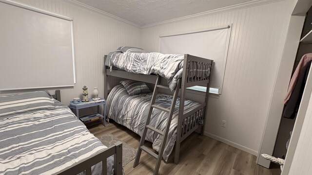 7741 White Birch St, Farwell, MI 48622 - bedroom featuring ornamental molding, wood finished floors, and a textured ceiling