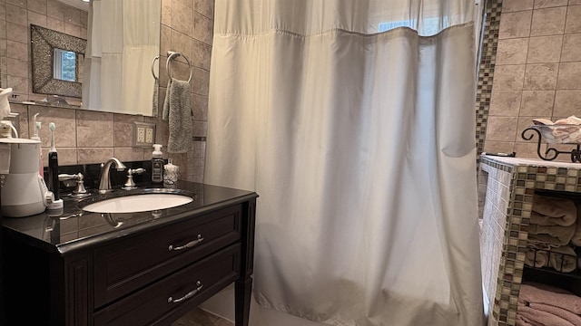 7741 White Birch St, Farwell, MI 48622 - full bath featuring decorative backsplash, vanity, a fireplace, a shower with shower curtain, and tile walls