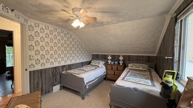 7741 White Birch St, Farwell, MI 48622 - bedroom with wallpapered walls, wainscoting, a textured ceiling, vaulted ceiling, and a ceiling fan