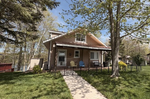 7741 White Birch St, Farwell, MI 48622 - rear view of property featuring covered porch, a yard, metal roof, and a standing seam roof