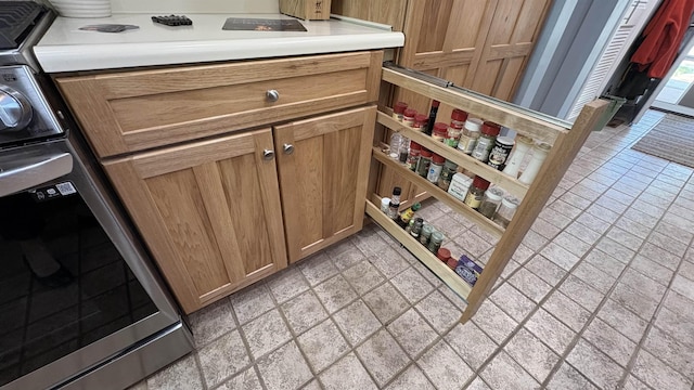 7741 White Birch St, Farwell, MI 48622 - kitchen view of range, light countertops, and brown cabinets