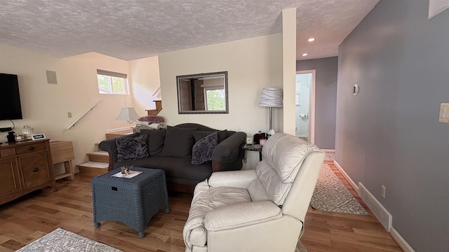 7741 White Birch St, Farwell, MI 48622 - living room with wood finished floors, a textured ceiling, baseboards, and recessed lighting
