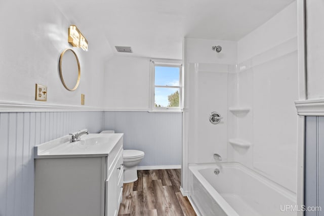 336 Fulton St, Mohawk, MI 49950 - full bath featuring toilet, wood finished floors, vanity, wainscoting, and shower / tub combination