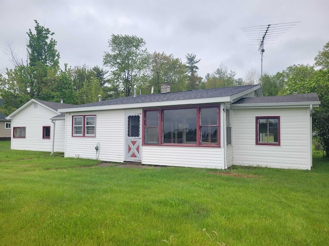 5523 Red Oak Rd, Beaverton, MI 48612 - view of front of home featuring a front lawn, a shingled roof, and a chimney