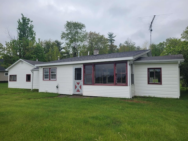 5523 Red Oak Rd, Beaverton, MI 48612 - back of property with a yard, a chimney, and a shingled roof