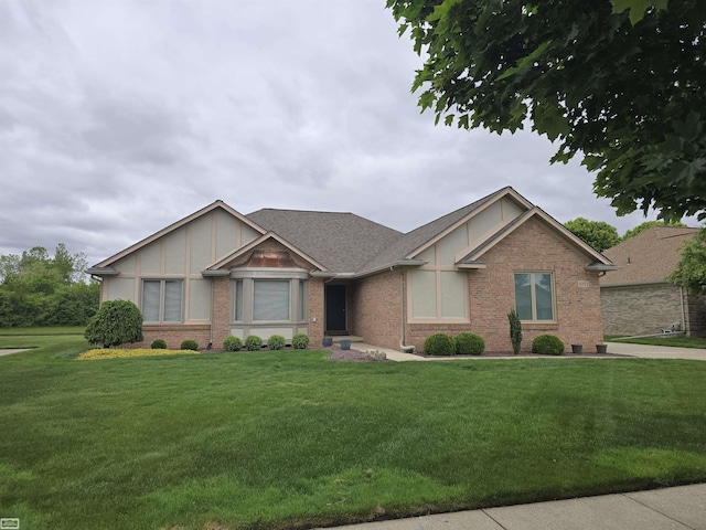 43173 Winterfield Dr, Sterling Heights, MI 48314 - view of front of property with brick siding, a front yard, and board and batten siding