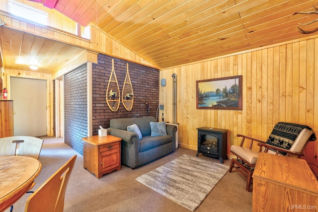 3159 N State Highway M94, Manistique, MI 49854 - living area featuring a wood stove, wooden ceiling, wooden walls, carpet floors, and vaulted ceiling