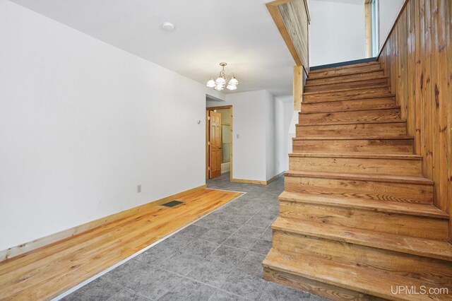 8413 Gay Park Rd, Lake Linden, MI 49945 - stairs featuring a chandelier and baseboards