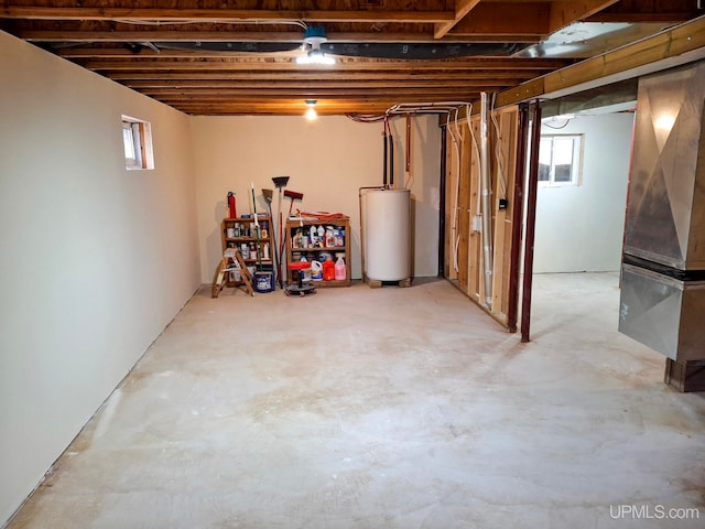 8413 Gay Park Rd, Lake Linden, MI 49945 - below grade area featuring water heater, plenty of natural light, and heating unit